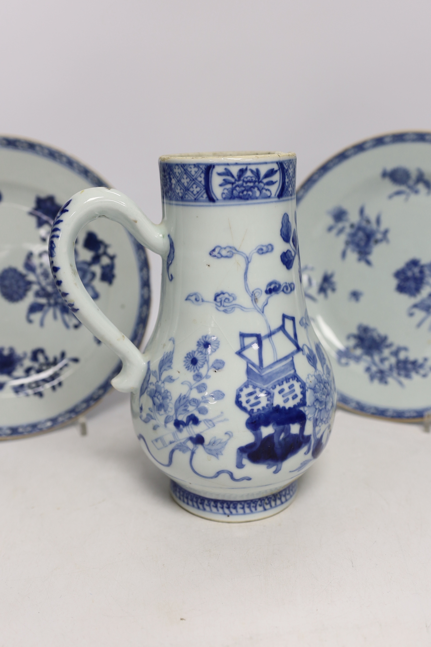 A Chinese 18th century reticulated double walled tea bowl and saucer, two blue and white plates and a jug (5)